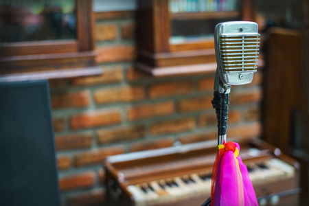 Old microphone with multicolored tieの写真素材
