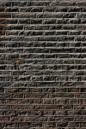 Brick wall. Amsterdam's traditional brickwork made of black bricks.