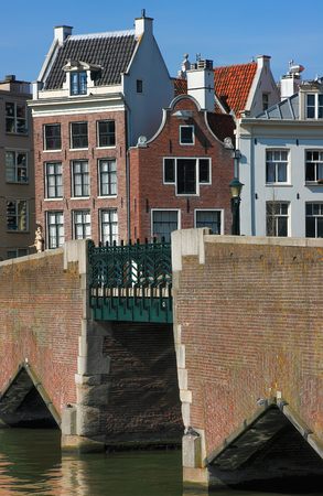 Bridges and houses of Amsterdam. Traditional dutch houses and the bridge near canal in Amsterdam, Netherlands.の写真素材