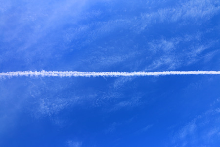 Trail of airplane in the blue sky.