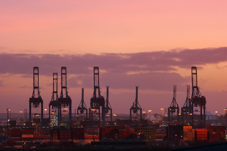 Hamburg, Germany - January 6, 2012. Cranes and shipyard of Hamburg port. Silhouettes of shipyard cranes against the background of the sunset sky.のeditorial素材