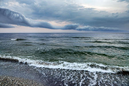 Dramatic sky with thunderstorm clouds over the sea coast.