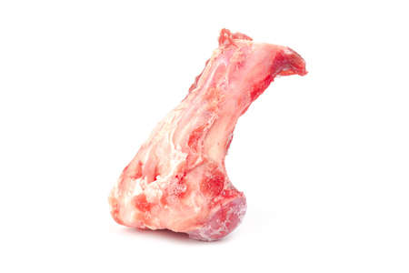 Close up frozen fresh pork bones with red meat stuck To be used for making pork bone broth on a white backgroundの写真素材