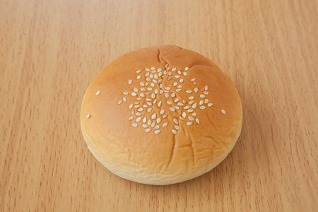 yellow bread  sprinkle sesame on a tableの写真素材