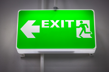 Fire exit signs green wall. Fluorescent lightの写真素材