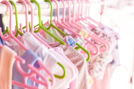 Baby clothes on a hangerの写真素材