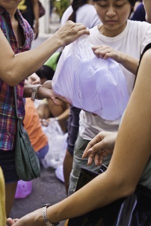 During the flood crisis, Thai peoples and foreigners in Bangkok still devote themselves to help Red-Cross foundation to prepare the disaster relief packages and send to the flood victims in the risky areas.のeditorial素材