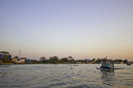 The beautiful river scene shows the traditional passenger boat is passing by.のeditorial素材