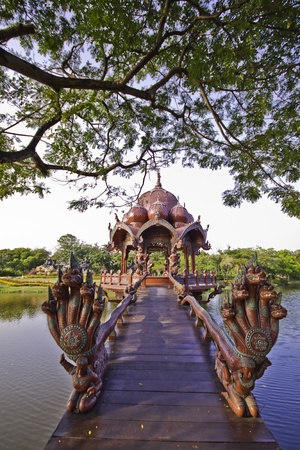 The beautiful red wooden Garuda shrine in the outdoor landscape at the ancient city in Samutprakarn of Thailand の写真素材