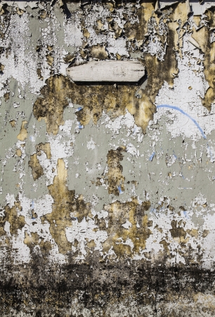 The aged grungy cement wall texture with patch as the design artwork background の写真素材