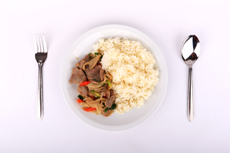 Rice and Fried beef with oyster sauce on white dish, isolatedの写真素材