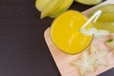 Star apple juice or averrhoa carambola squash on wooden block. Fresh star apple juice on wood table.の写真素材