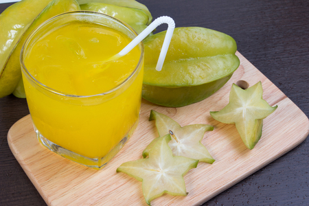 Star apple juice or averrhoa carambola squash on wooden block. Fresh star apple juice on wood table.の写真素材