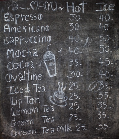 menu in front of coffee, chalk on black board: coffee, espresso, cappuccinoの写真素材