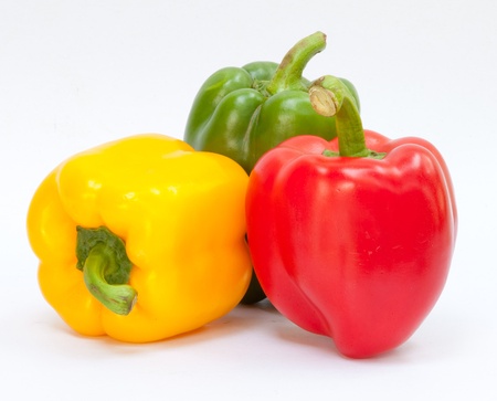Three sweet peppers in yellow, red and green color
