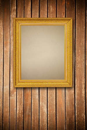 Gold frame on wood wall backgroundの写真素材