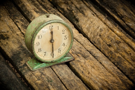 old clock on old wooden surface の写真素材