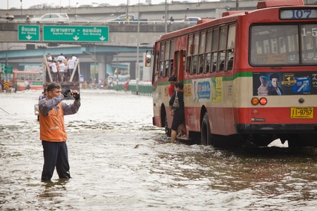 BANGKOK, THAILAND - NOVEMBER 5 : A man take photo flood hits Central of Thailand, higher water levels expected, cars navigating through the flood on November 5,2011 Bangkok, Thailand.のeditorial素材