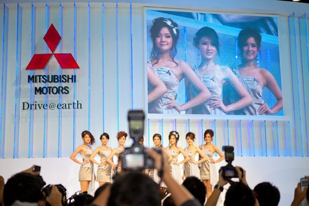 BANGKOK, THAILAND - DECEMBER 3,2011: Unidentified females presenter at Mitsubishi booth in the 28th Thailand International Motor Expo 2011 on December 3, 2011 in Nonthaburi, Thailand.のeditorial素材