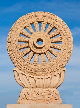 wheel of dhamma of buddhism with blue skyの写真素材