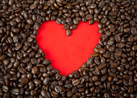 heart from coffee beans on redの写真素材