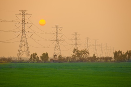 Electric power station in the field on sunset