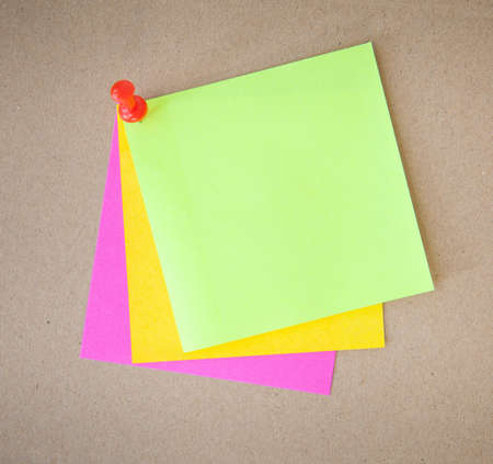 color paper and pin on wood texture background
