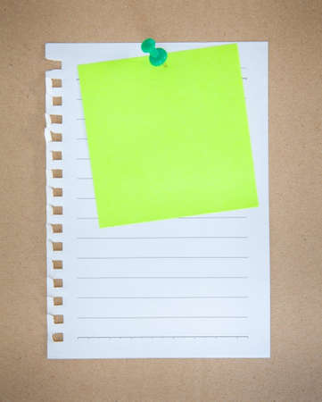 paper sheet and pin on wood texture backgroundの写真素材