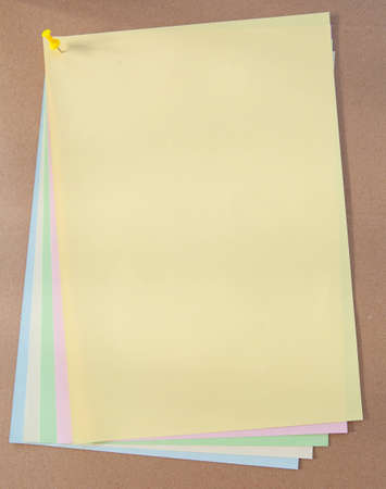 color paper and pin on wood texture background