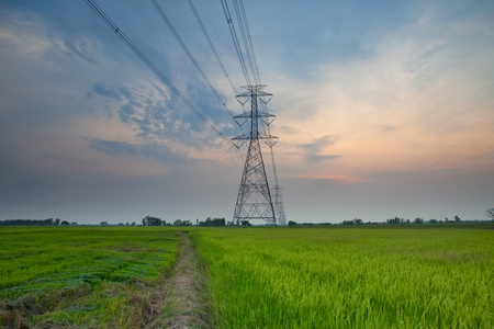 Electric power station in the field on sunset
