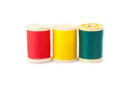 red yellow green thread on white background