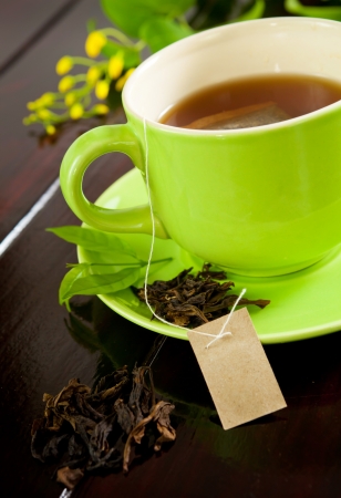 green cup of hot tea on wood backgroundの写真素材