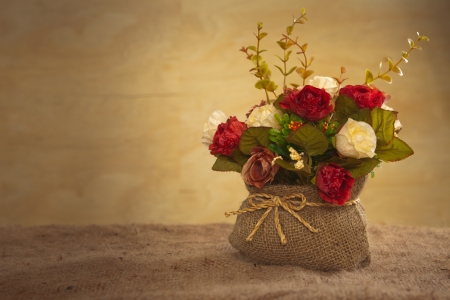 still life with rose flower on hessian backgroundの写真素材
