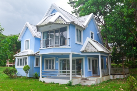 Beautiful blue house and big tree in forestのeditorial素材