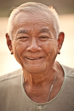 Portrait Of Happy Senior Asian Man At Outdoorの写真素材