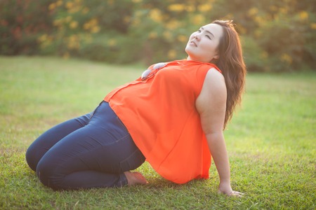Happy fatty asian woman posing outdoor in a parkの写真素材