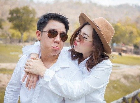 Happy young asian couple in love outdoorの写真素材