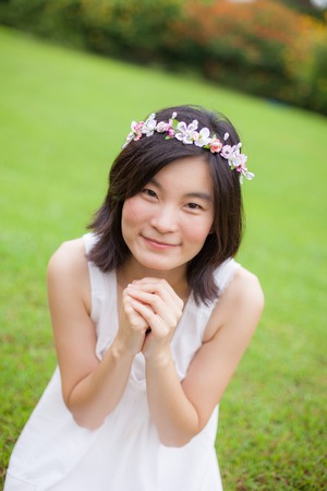 Beautiful asian young woman with a crown of flowersの写真素材
