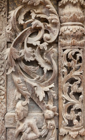 Old wood carvings on the wall temple in Myanmar
