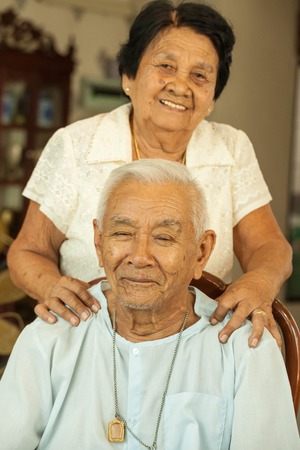 Senior woman giving a massage to her husband at home