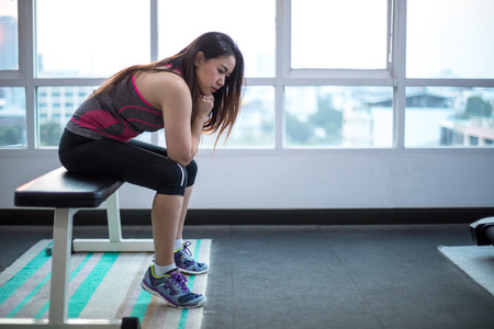 Young asian woman frustrated and tired in sport club