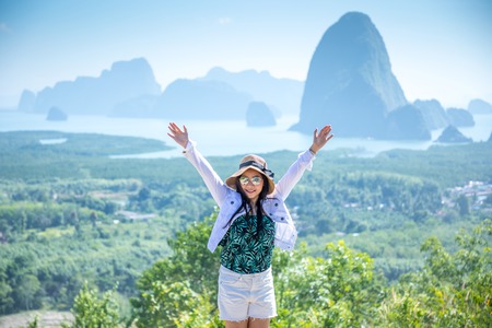 cheering woman hiker open arms  at Phang Nga Bay from Samed Nang Chee, Thailandの写真素材