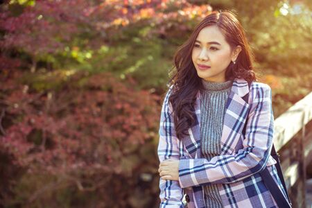 Portrait of young asian girl in autumn parkの写真素材