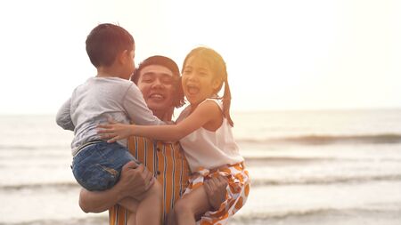 Happiness Father and son and daughter playing on the beachの写真素材