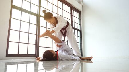 Teacher teaching taekwondo girl, Korean martial art