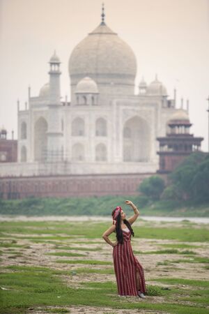 Indian woman in red saree/sari in the Taj Mahal, Agra, Uttar Pradesh, Indiaのeditorial素材