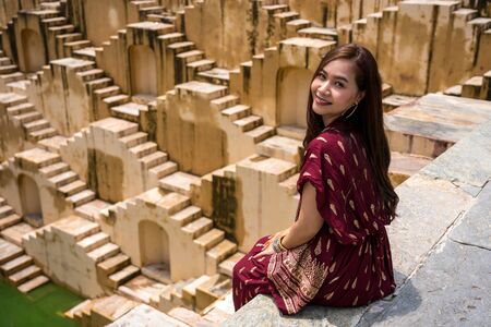 Asian woman posing at Panna Meena Ka Kund stepwell in Jaipur,Rajasthan, Indiaの写真素材