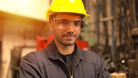 Portrait of engineer man posing at factory