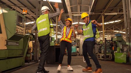 Happy Team Of Engineers dancing In Factoryの写真素材