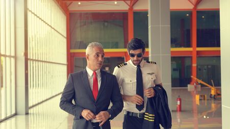 Pilot and boss talking at the airport terminal